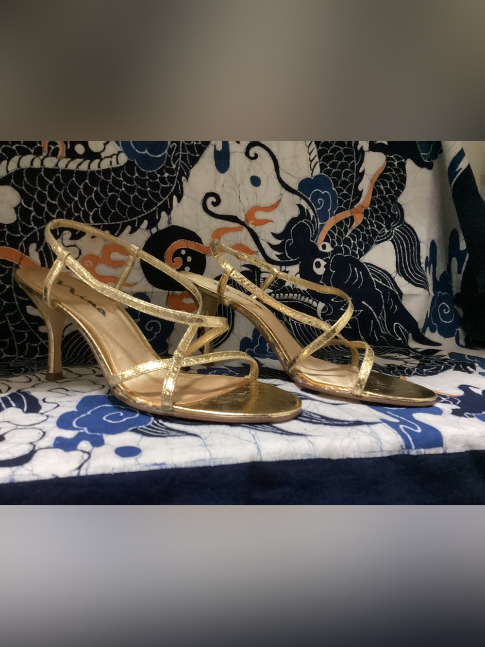 Women’s gold Nina heel sandals, featuring delicate ankle straps & stiletto heels